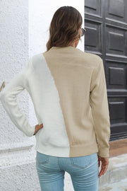 Diagonal knit sweater in beige and cream with a colorblock design.