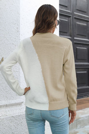 Diagonal knit sweater in beige and cream with a colorblock design.