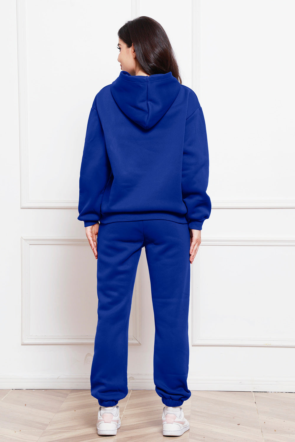Blue relaxed fit hoodie and joggers set with cuffed ankles.