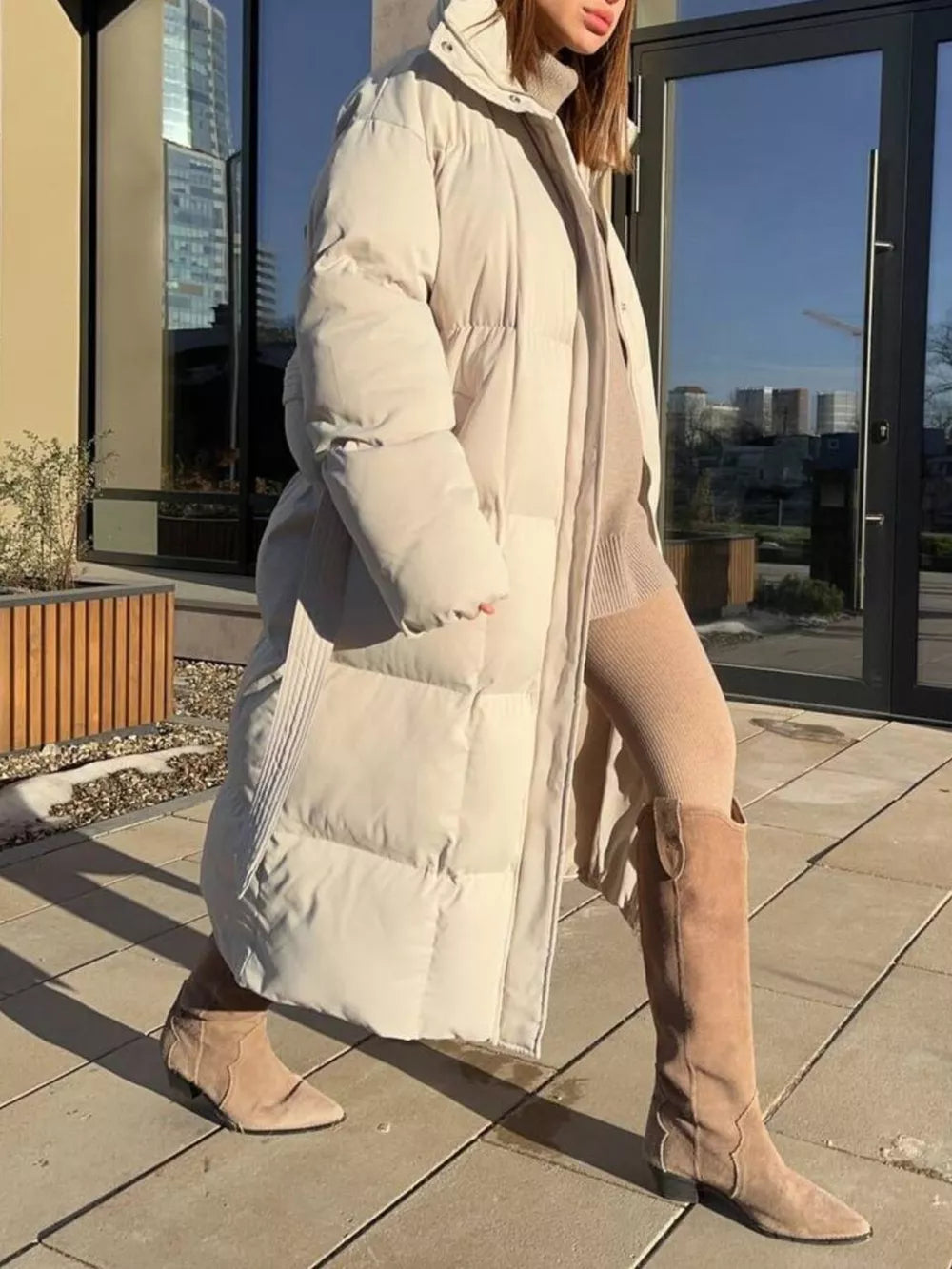 Ivory white padded trench coat with tie-belt and hood, long sleeves, full length