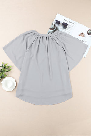 Gray relaxed V-neck blouse with cap sleeves and gathered neckline detail