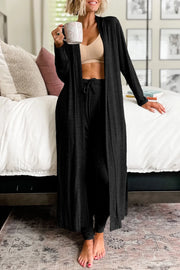 Black duster cardigan and jogger set with drawstring waist, worn with a bralette.