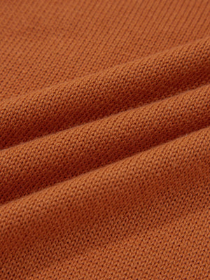 Caramel acrylic blend sweater with a textured knit and draped fabric detail.
