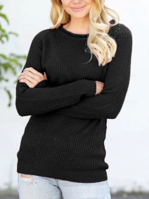 Black acrylic knit pullover sweater with honeycomb texture and raglan sleeves.