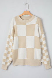 Beige and white checkerboard knit sweater with crewneck and ribbed cuffs and hem.
