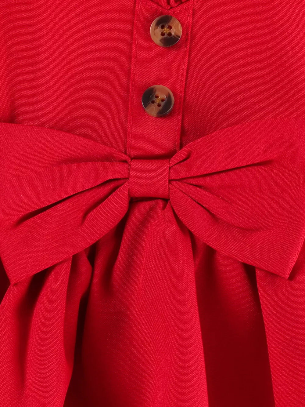 Red baby top with bow detail and button front, part of a set with denim shorts.