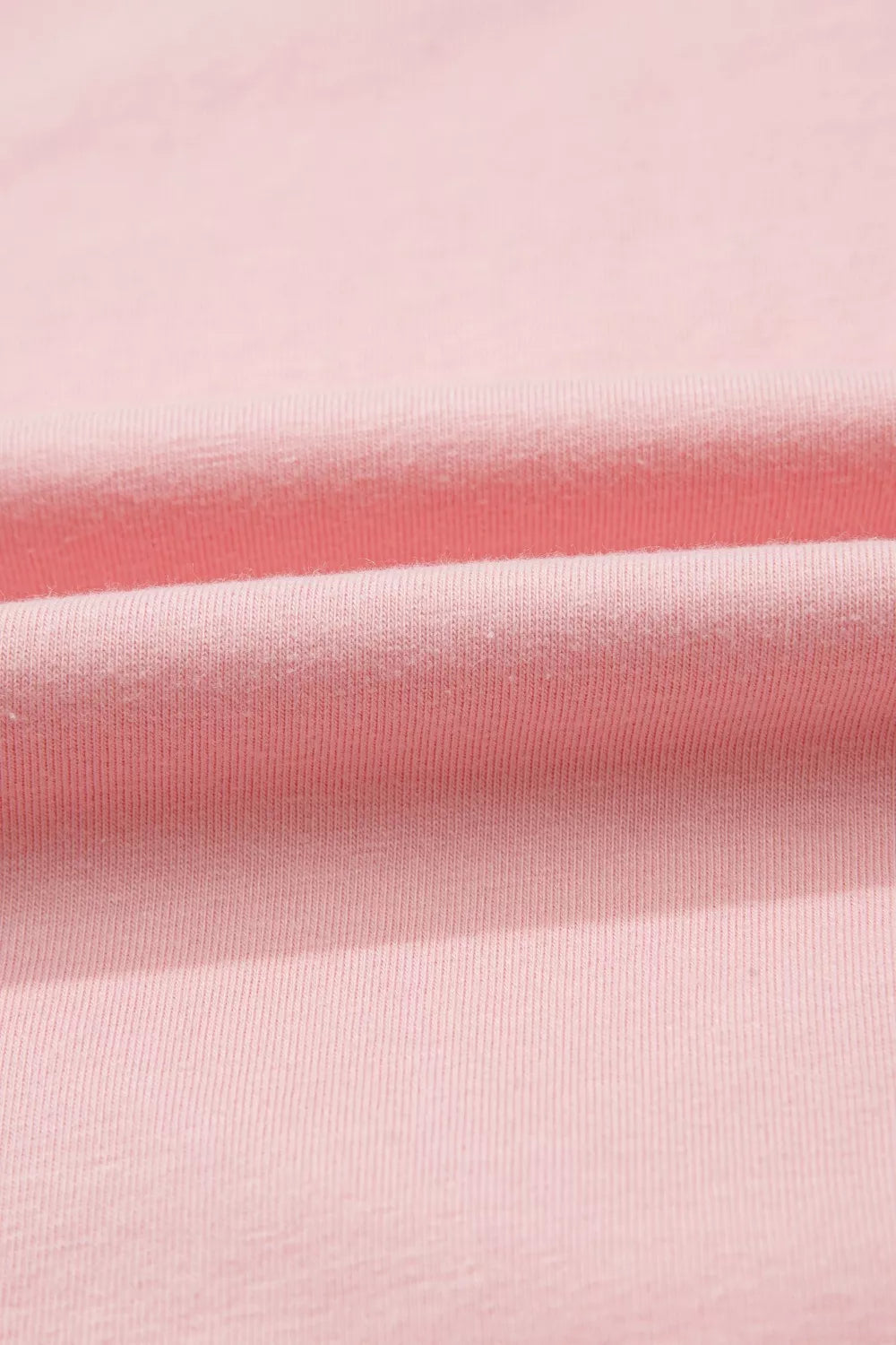 Pink cotton maternity t-shirt with subtle ribbing and soft folds.