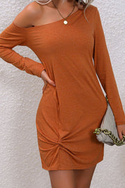 Caramel asymmetric knot-front mini dress with one-shoulder neckline and long sleeves.