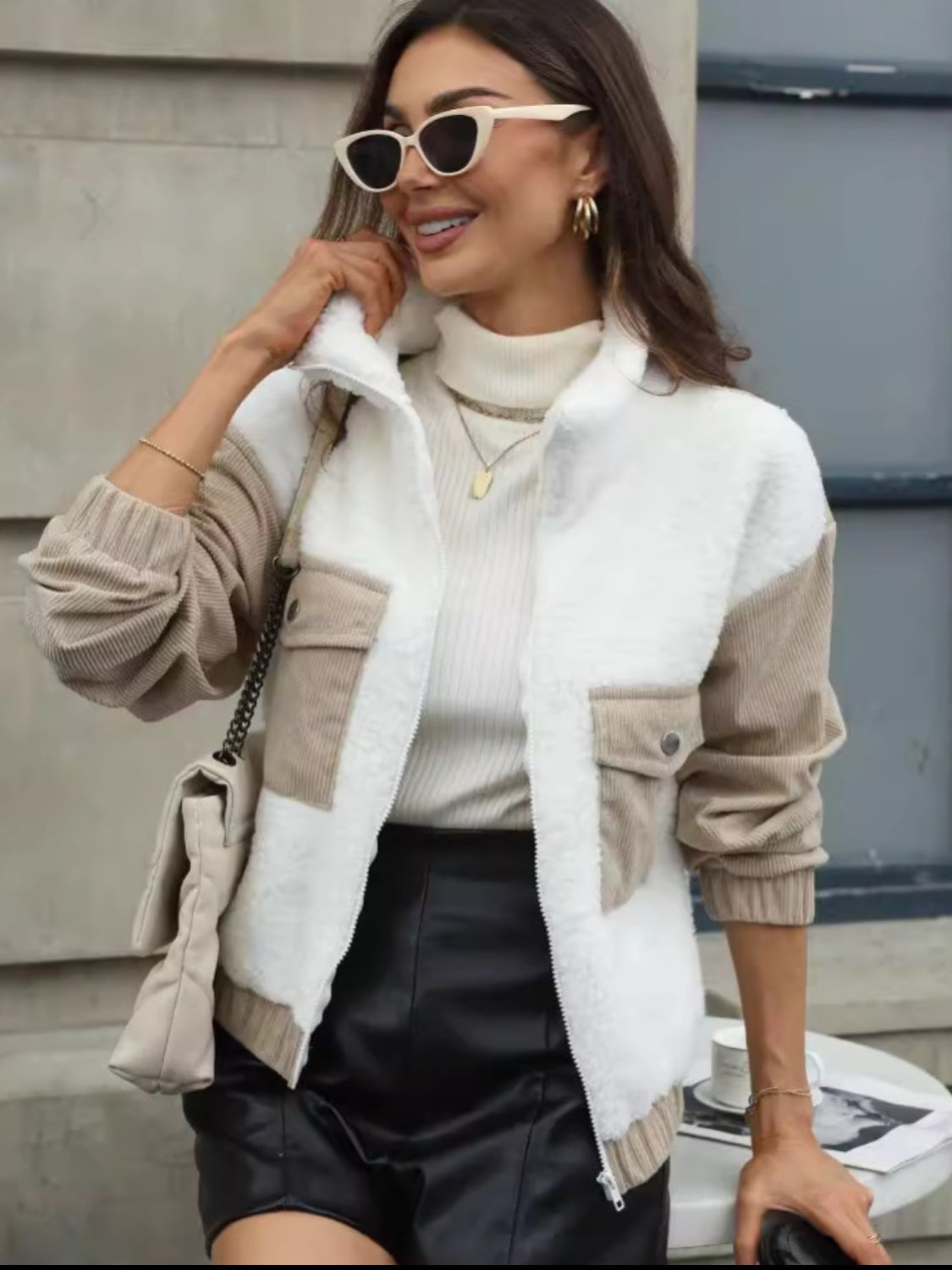 Colorblock sherpa and corduroy zip jacket in white with tan sleeves and pockets.