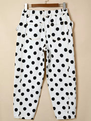 White polka dot denim jeans with high waist and bow details.