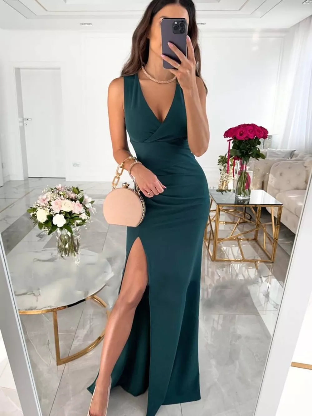Elegant ruched maxi dress in deep green with a plunging neckline and high slit.