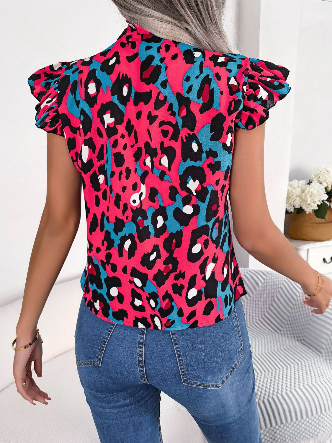 Hot pink leopard print blouse with ruffled sleeves and a pussybow detail.