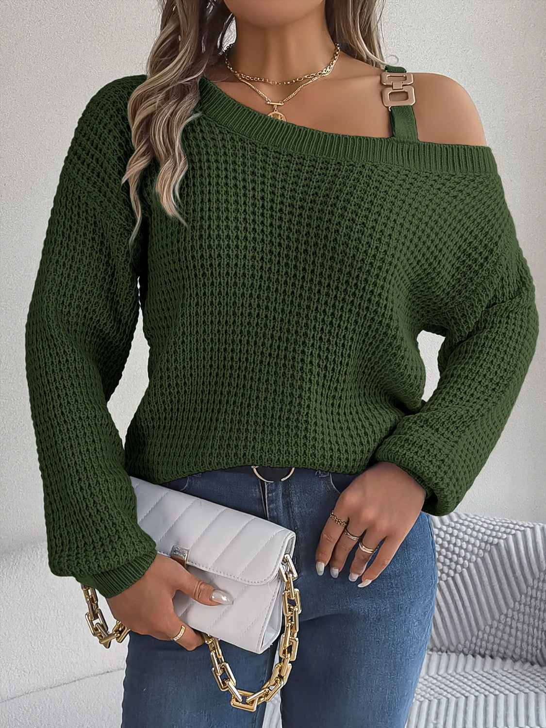 Army green one-shoulder knit sweater with buckle detail and waffle texture.
