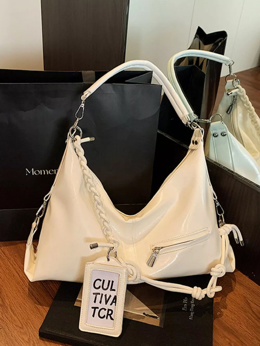 White braided strap shoulder bag with zip pocket and tag detail