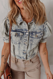 Cropped denim bolero jacket in medium wash with puff sleeves and distressed details.