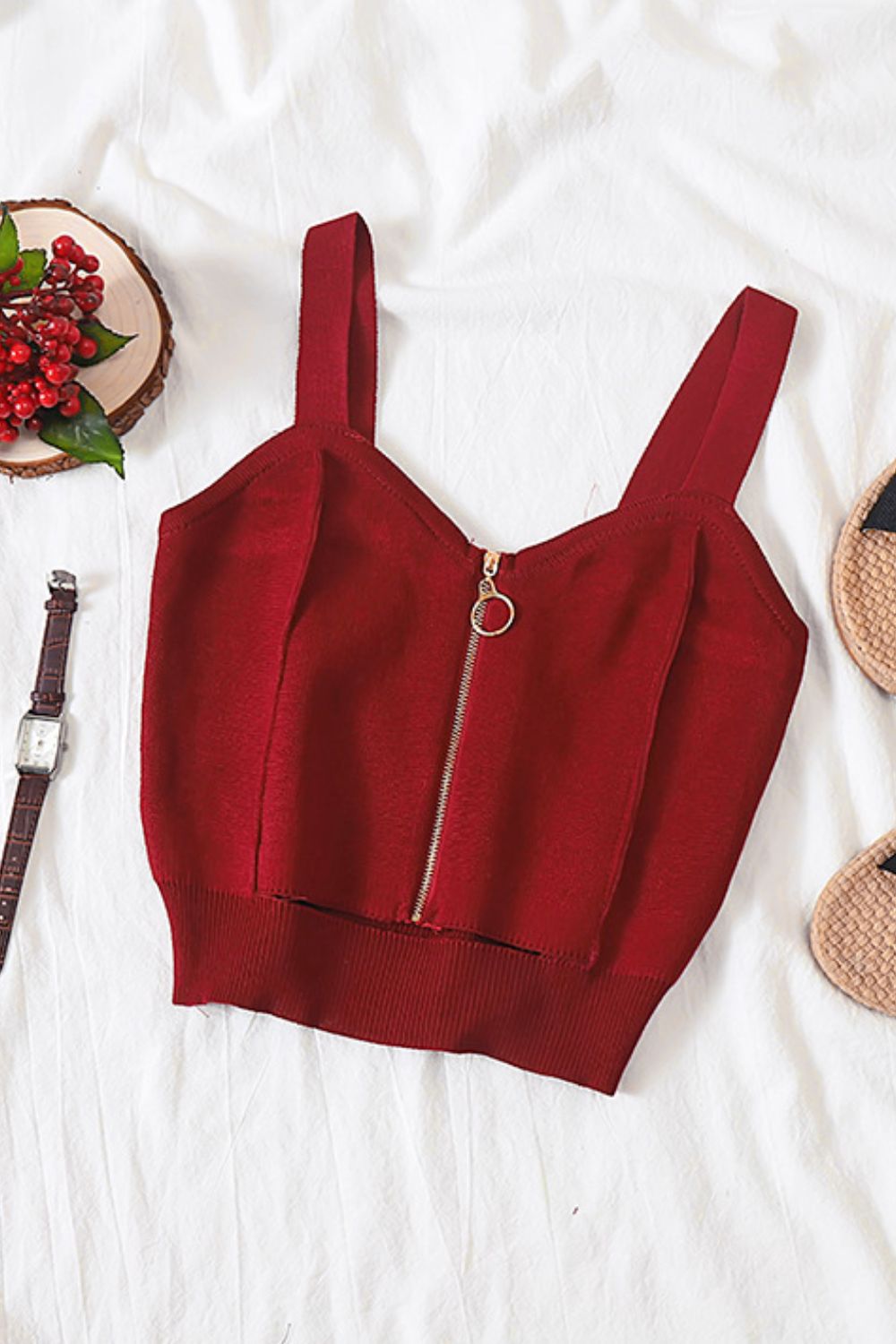 Burgundy ribbed knit crop top with exposed zip detail and square neckline.