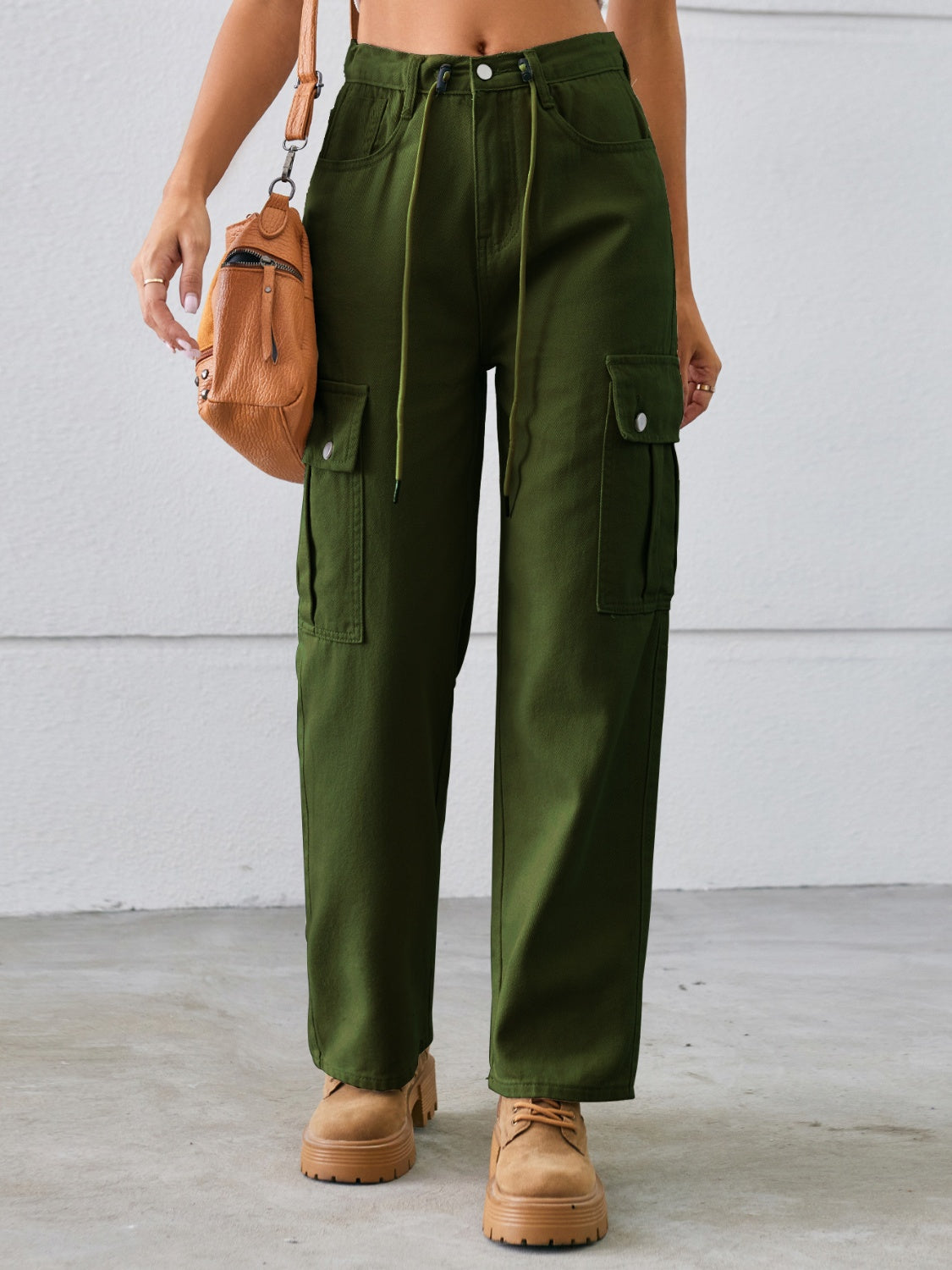 Army green denim cargo pants with drawstring waist and wide legs.