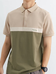 Men's color block polo shirt in beige and olive green with "POSITIVE" embroidery.