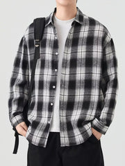 Relaxed fit cotton button-up shirt in Black And White Grid plaid with collared neckline.