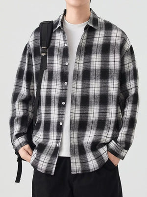 Relaxed fit cotton button-up shirt in Black And White Grid plaid with collared neckline.