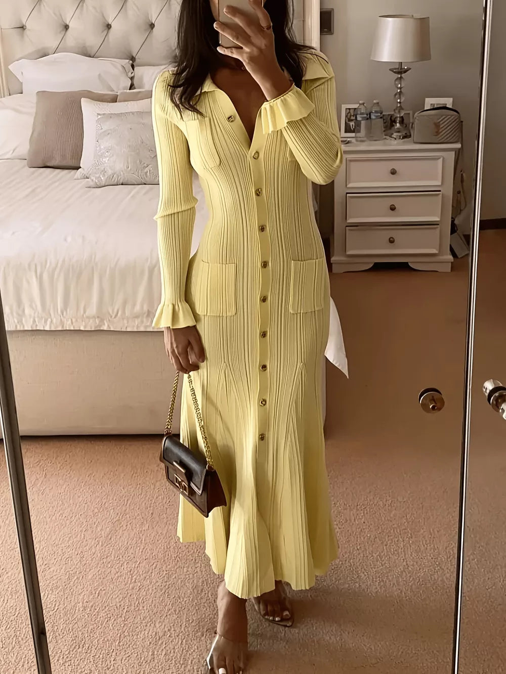 Yellow knit polo collar sweater dress with button front, pockets, and ruffled cuffs.