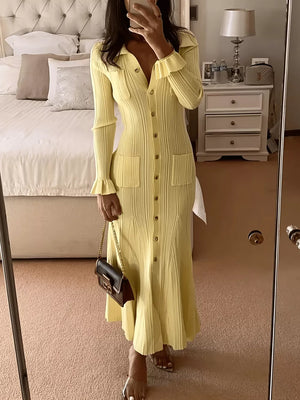 Yellow knit polo collar sweater dress with button front, pockets, and ruffled cuffs.