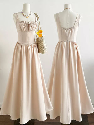 Elegant square neck A-line maxi dress in beige with drawstring bodice and full skirt.