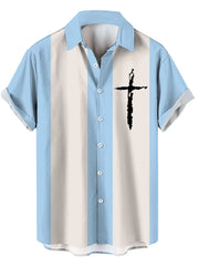Pastel blue and cream striped casual shirt with black cross graphic and button-up front.