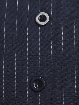Chic striped halter jumpsuit in navy with decorative buttons.