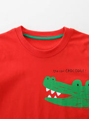 Red cotton blend toddler t-shirt with playful green crocodile print and text.