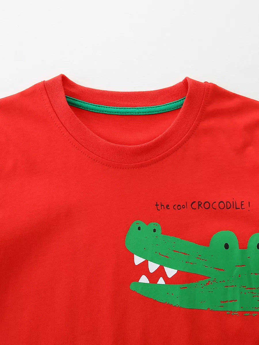 Red cotton blend toddler t-shirt with playful green crocodile print and text.