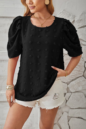 Black textured puff-sleeve blouse with pom-pom details and round neckline.
