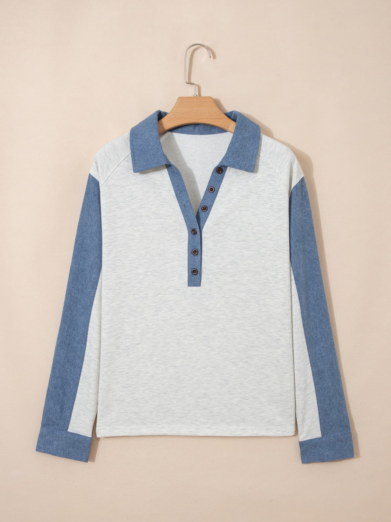 Heathered casual long sleeve top with button detail and color-blocked blue sleeves.