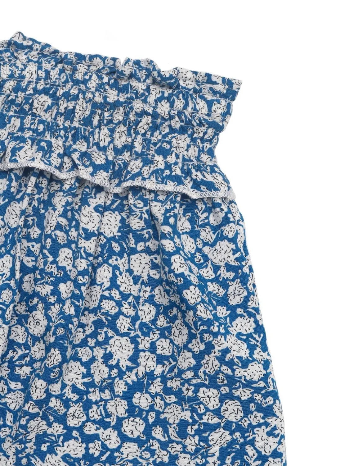 Light blue mini skirt with ditsy floral print and ruffled smocked waist.