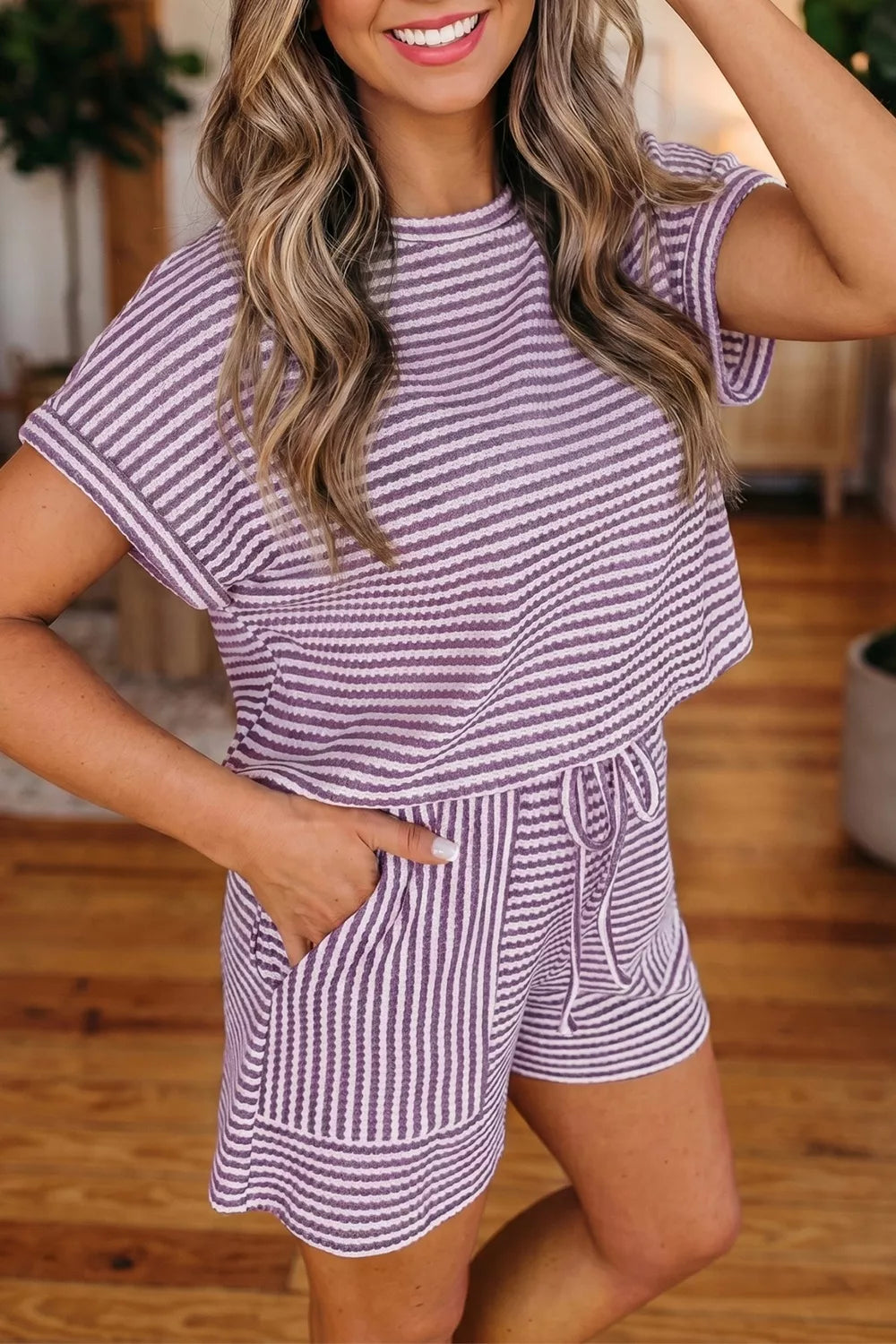 Purple striped textured knit two-piece set with crew neck top and drawstring shorts.