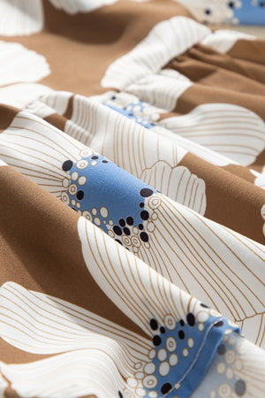 Camel floral print blouse with a Peter Pan collar detail and ruffled trim.