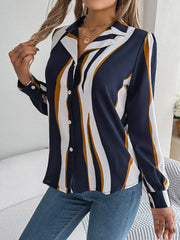 Collared blouse with wavy dark blue, white, and gold stripes, button front, and long sleeves.