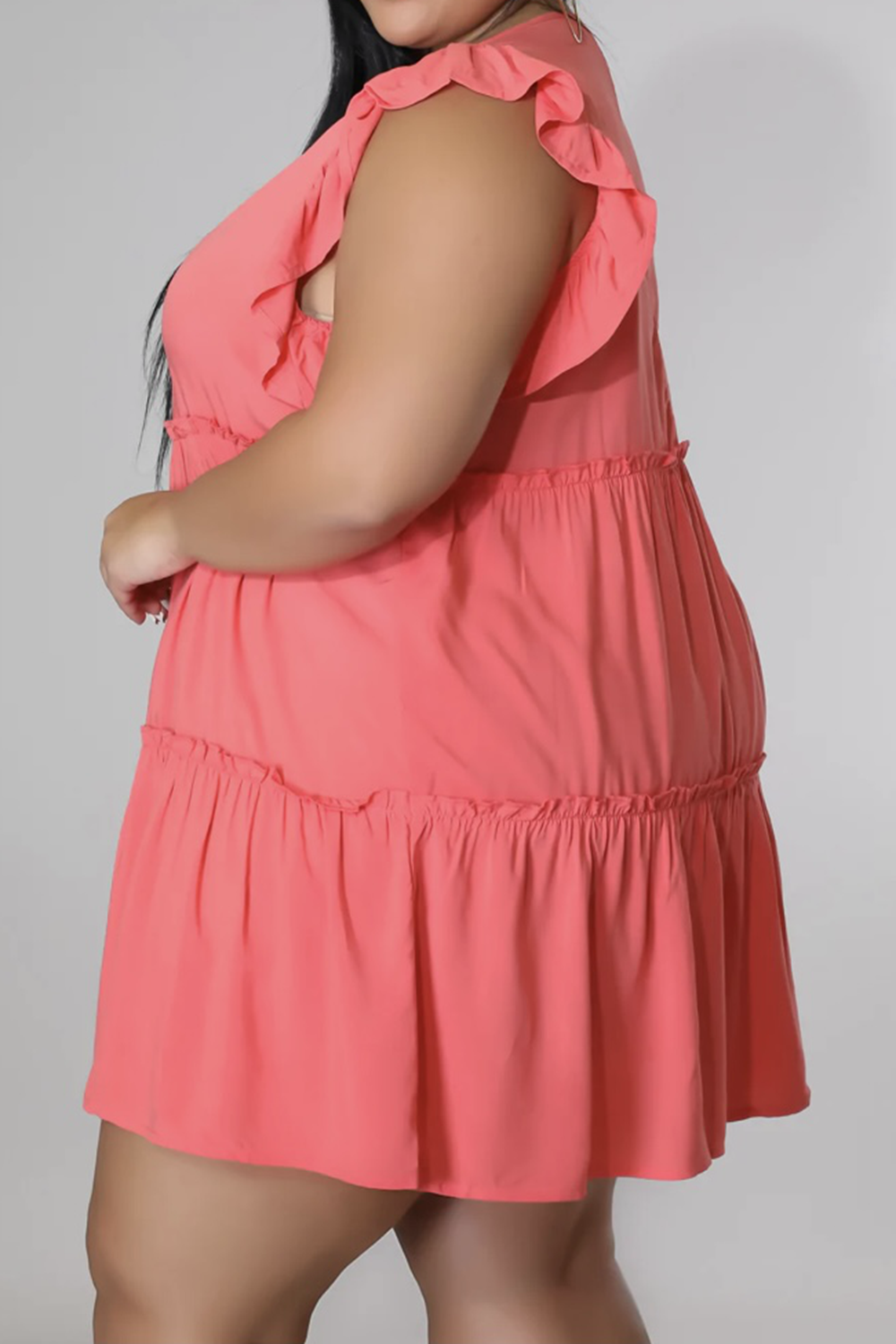 Coral tiered ruffle babydoll mini dress with flutter sleeves.