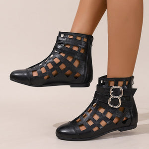 Black ankle cutout boots with buckles and adjustable straps.