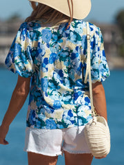 Vibrant floral print cotton blouse with puff sleeves and a casual fit.