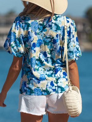 Vibrant floral print cotton blouse with puff sleeves and a casual fit.