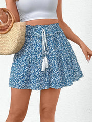Light blue ditsy floral mini skirt with ruffled hem and drawstring waist.