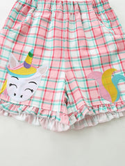 Toddler pink plaid cotton shorts with ruffled hem and unicorn applique.