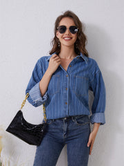 Vertical stripe denim overshirt in medium blue with two chest pockets and button front.