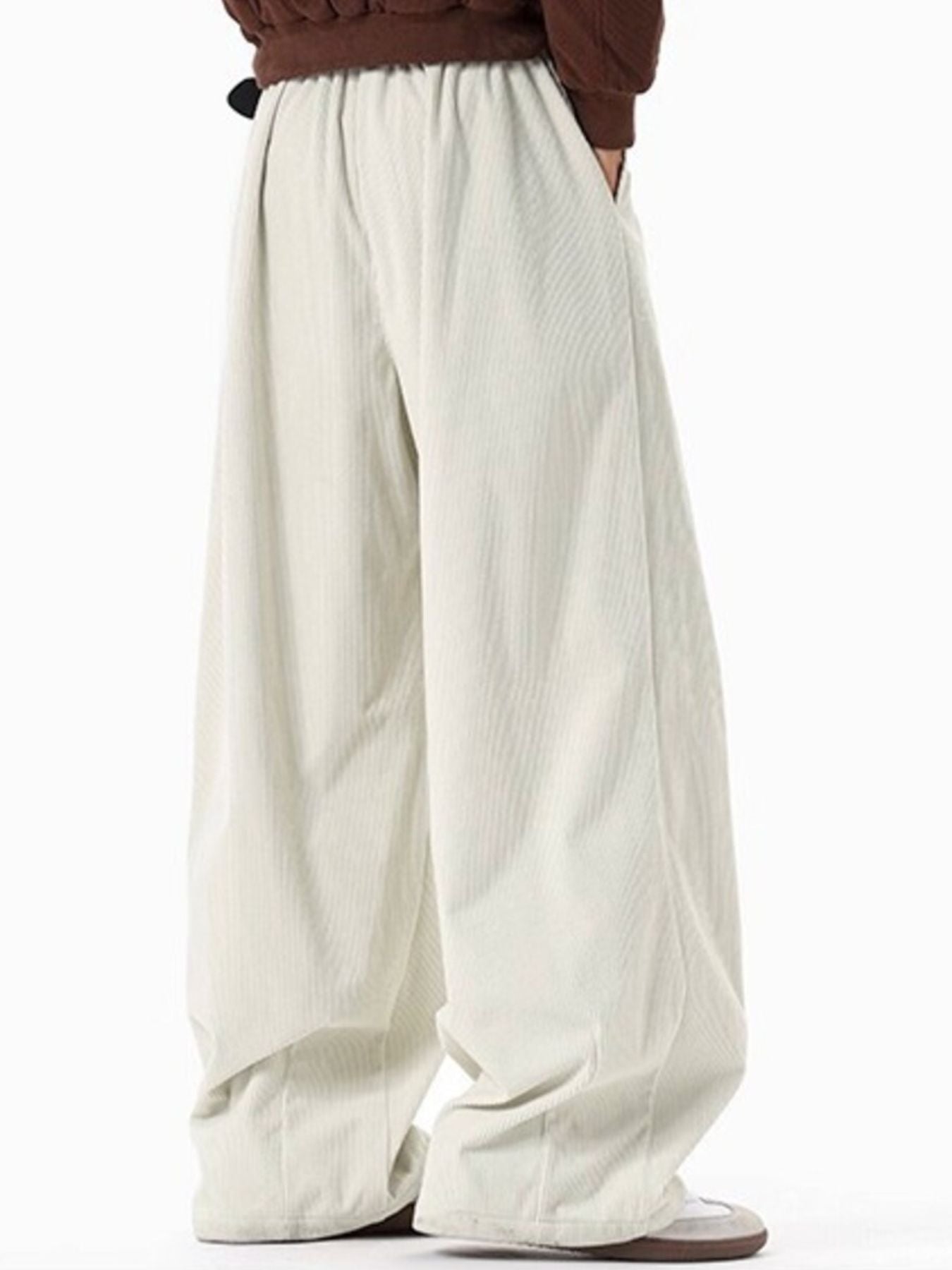 Men's cream corduroy pleated wide leg trousers with elastic waistband