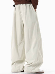 Men's cream corduroy pleated wide leg trousers with elastic waistband