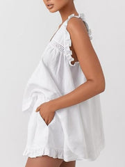 White ruffled V-neck top and shorts set with lace detail and pockets