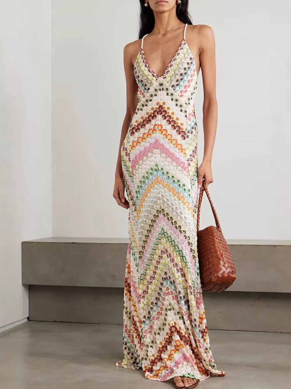 Chevron knit maxi dress with V-neck and crisscross straps in colorful pattern.