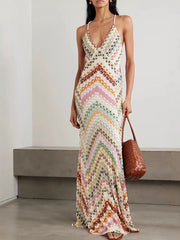 Chevron knit maxi dress with V-neck and crisscross straps in colorful pattern.