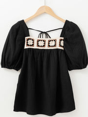 Black gauze blouse with puff sleeves and a square neckline featuring a crochet yoke detail.